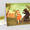 A greeting card with an illustration of a girl in an orange dress dancing with a black bear near a striped tent and trees.