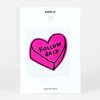 A packaged pink heart-shaped puffy sticker with black outline and the words "FOLLOW BACK" printed on it, with "ADAM.JK" and "Jumbo Puffy Sticker" visible on the backing card.