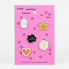 A set of five enamel-style pins on a pink backing card, including a jar labeled "FEEL-INGS," a gold star reading "YOU TRIED," a black blob reading "THE UNKNOWN," a white circular pin with "YES," "NO," "MAYBE," and "IDK," and a heart reading "IDK."
