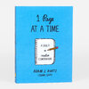 A bright blue book cover reads "1 Page AT A TIME" and shows a spiral notebook with a pencil and the text "A DAILY creative COMPANION," with "ADAM J. KURTZ (SOME GUY)" at the bottom.
