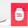A red greeting card with scalloped edges featuring a chenille-style jar patch and the embroidered text "FEEL-INGS" in the center.