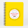 A bright yellow spiral-bound planner with rounded corners and a white circular label reading "UNDATED 52-WEEK PLANNER," "ADAM J. KURTZ," and "UNSOLICITED ADVICE."