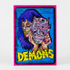 A postcard-sized print featuring a neon pink border, a blue VHS-style horror illustration with two demonic faces, and the word "DEMONS" in large yellow letters.