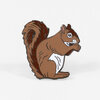 A brown squirrel enamel pin with a white belly, dark red-brown tail, and black-outlined details.
