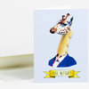 A folded greeting card shows an illustrated giraffe in a blue suit with a bandaged head and the text "FEEL BETTER!" on a yellow ribbon banner.