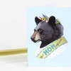 A light blue greeting card shows an illustrated bear wearing a flower crown and a sash that reads "BEST MOM EVER."