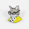 An enamel pin shaped like a tabby cat wearing black glasses, a white collared shirt, and a bright yellow jacket.