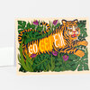 A folded greeting card featuring an illustrated tiger lying in dense green jungle foliage with the words "GO GET EM" across its body.