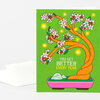 A folded greeting card with a bright green cover showing an orange flowering bonsai tree in a pink pot and the text "YOU GET BETTER EVERY YEAR".