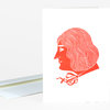 A folded greeting card with a red side-profile illustration of a woman with wavy hair and a bow at her neck on the front.