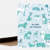 A folded greeting card featuring illustrated dogs with halo rings and the text "ALL DOGS GO TO HEAVEN" on the front.