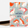 A folded greeting card with a light blue cover patterned with orange and white cats and the text "I HOPE YOUR BIRTHDAY IS FULL OF CATS" in dark blue.