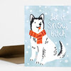 A folded greeting card shows a black-and-white dog wearing an orange scarf beside the text "Let it snow, bitch" on a light blue background with white snowflakes.