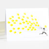 A folded greeting card shows a small illustrated girl roller skating while holding a cluster of many yellow balloons.