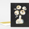 A folded greeting card featuring a stylized bouquet of four pale yellow and white flowers in a white vase on a black background.