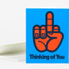 A blue greeting card with a large orange hand making a peace sign and the text "Thinking of You" on the front.