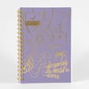 A lavender planner or notebook cover with metallic yellow spiderweb line art, two hanging moon-themed squares, a small spider illustration, and the text "dreaming the World to come."