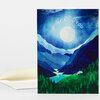A folded greeting card with a blue mountain landscape illustration and the curved white text "THINKING of YOU" on the front.