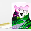A greeting card with a stylized bear face and colorful mountain landscape, with the text "HAPPY BIRTHDAY" across the bottom.