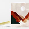 A folded greeting card with an abstract canyon illustration in muted beige, red, rust, tan, and dark green shapes and a white sun circle.