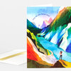 A folded greeting card with a colorful abstract mountain landscape illustration and the text "YOU'RE ON YOUR WAY" on the front.