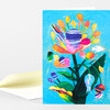 A folded greeting card with a colorful abstract wildflower bouquet illustration and a matching envelope.