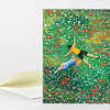 A greeting card featuring two people lying in a dense green meadow filled with colorful flowers.