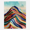 An abstract print showing a mountain-like form made of layered rainbow-colored bands beneath a pale blue sky.