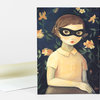 A folded greeting card shows an illustration of a young girl with a black eye mask and short brown hair, wearing a pale collared shirt against a dark floral background.