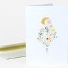 A folded greeting card with a botanical illustration of a person holding a bouquet of flowers, including a yellow shape where the hair or head would be.