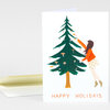A folded greeting card shows a woman in an orange top decorating a green pine tree with small mushrooms, with the text "HAPPY HOLIDAYS" at the bottom.