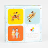 A square Dream World Matching Game box featuring four illustrated panels with a child riding a tiger, a child riding a narwhal, two costumed children with a cat, and a title panel that reads "Emily Winfield Martin DREAM WORLD MATCHING GAME."