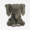 A gray plush elephant stuffed animal with large floppy ears, a long trunk, small black eyes, and white toe details.