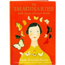 A hardcover book titled "The IMAGINARIES: Little Scraps of Larger Stories" by Emily Winfield Martin with a red-orange cover featuring an illustrated woman surrounded by butterflies, plus a small inset image of a woman in a white dress sitting on a crescent moon among stars.