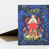 A greeting card with the word "CANCER" at the top and an illustrated crab-headed figure surrounded by stars and flowers on a dark blue background.
