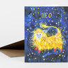 A folded greeting card featuring the word "LEO" above a yellow lion-like figure surrounded by stars on a dark blue background.