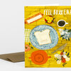 A greeting card with the text "FEEL BUTTER!" showing a slice of toast on a patterned blue plate with a butter dish, cup of coffee, flowers, and a red teapot on a yellow background.