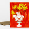 A folded greeting card with a vivid red front featuring a white classical bust turned into a vase of bright yellow flowers and green stems.