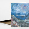 A folded birthday greeting card with an illustrated coastal harbor scene and the words "HAPPY BIRTHDAY" on the front.