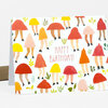 A folded greeting card printed with a repeating pattern of mushroom-shaped figures with legs, leaves, and the centered text "HAPPY BIRTHDAY!".