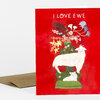 A red greeting card with the text "I LOVE EWE" above an illustration of a white ewe and lamb with a floral arrangement growing from the ewe's back.