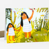 A folded greeting card with an illustrated mother and child in a leafy jungle scene and the text "I LOVE YOU, MOM!" on the front.