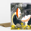 A greeting card with the text "I LOVE YOU!" and an illustration of two mushroom-like faces surrounded by small yellow and white flowers.