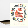 A folded greeting card with a cream cover showing two orange birds inside a circular floral wreath and the text "YOU ARE A STELLAR DAD".