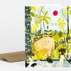 A folded greeting card featuring an illustrated tropical bath scene with the text "THANK YOU!" and a brown envelope behind it.