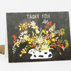 A folded greeting card with the text "THANK YOU!" above a white dalmatian surrounded by colorful flowers and foliage on a dark background.