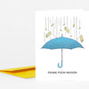 A folded greeting card with an illustration of a blue umbrella raining pasta shapes and the text "PENNE FROM HEAVEN" on the front.