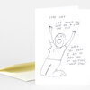 A folded greeting card with a black line drawing of a kneeling figure raising both arms and handwritten text that reads, "LORD WHY WHY WOULD YOU GIVE ME A LOVE LIKE THIS WHEN YOU KNOW I AM SO VERY BAD AT WRITING LOVE SONGS!"