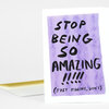 A folded greeting card with a purple rectangular panel and bold black hand-lettered text that reads "STOP BEING SO AMAZING!!!! (JUST KIDDING, DON'T)".