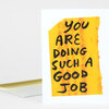 A folded greeting card with a yellow block and hand-painted black text reading "YOU ARE DOING SUCH A GOOD JOB" on the front.